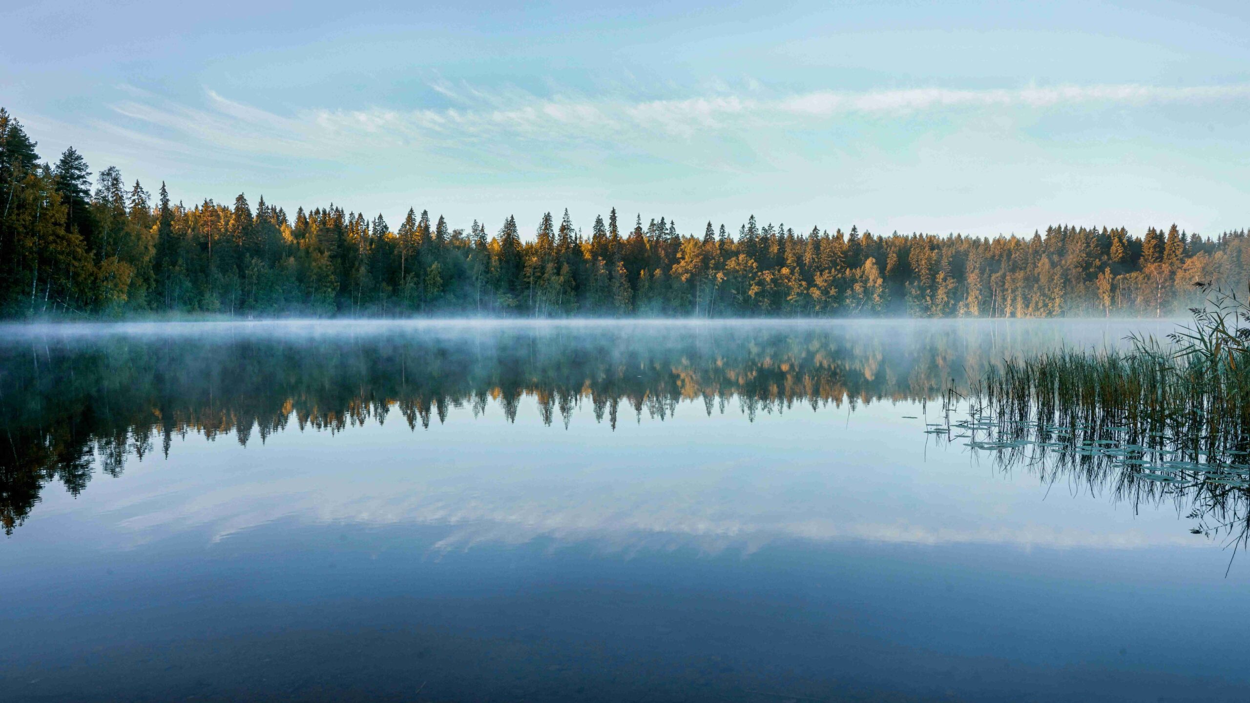 Wooden sauna cabin by frozen lake in Finland